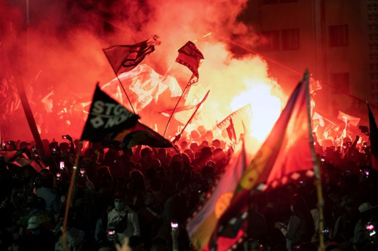 Demonstrators supporting the reform of the Chilean constitution celebrate while waiting for the referendum official results at Plaza Italia square in Santiago on October 25, 2020