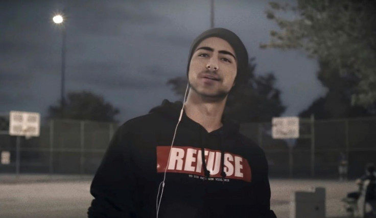 "Yo, it's me" opens AI Joaquin, wearing a sweatshirt and beanie as he speaks in front of a basketball court, to a backdrop of eerie music