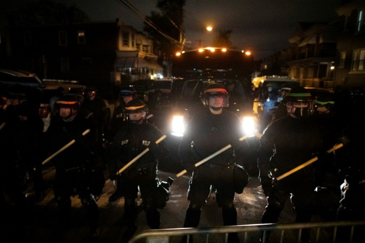 Police in tactical gear form a line facing demonstrators near the location where Walter Wallace, Jr. was killed by two police officers on October 27, 2020 in Philadelphia, Pennsylvania