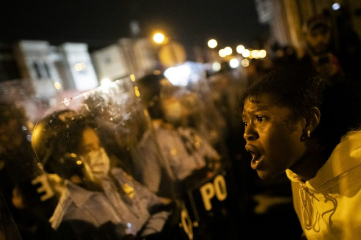 A demonstrator screams at a police line during a protest near the location where Walter Wallace, Jr. was killed by police officers