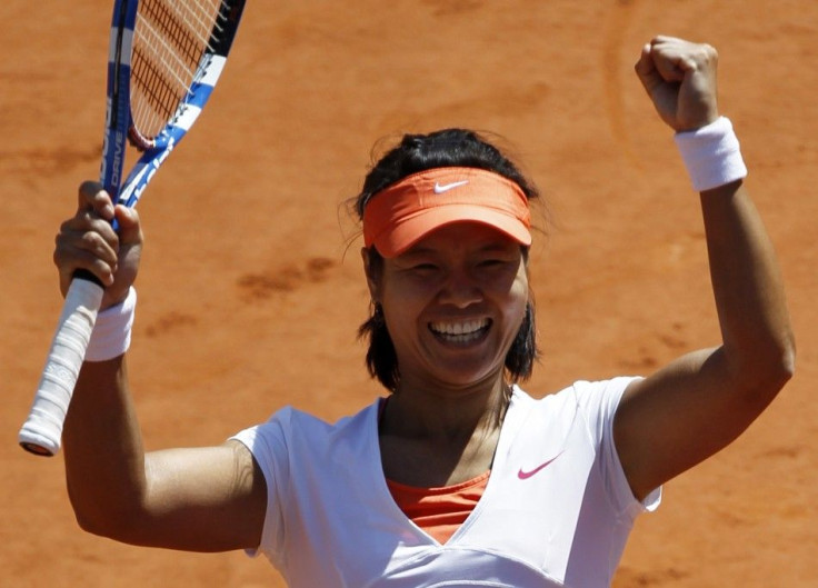 Li Na of China reacts after defeating Maria Sharapova of Russia during their semi-final match at the French Open tennis tournament at the Roland Garros stadium in Paris.