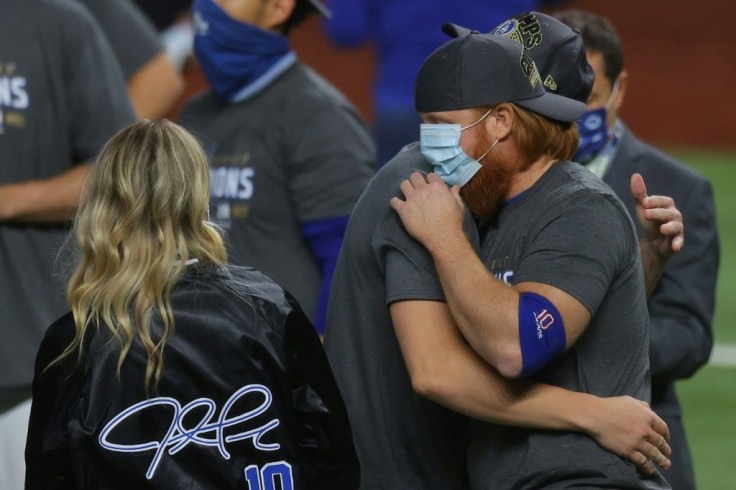 Justin Turner celebrates a World Series victory with Los Angeles Dodgers teammates despite being pulled from game six in the eighth inning after testing positive for coronavirus