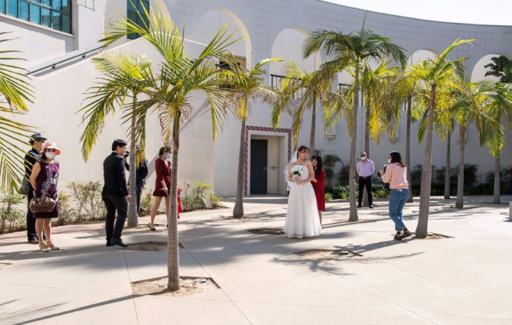 Facemasks and social distancing will forever be on this couple's wedding photographs to mark their Beverly Hills ceremony