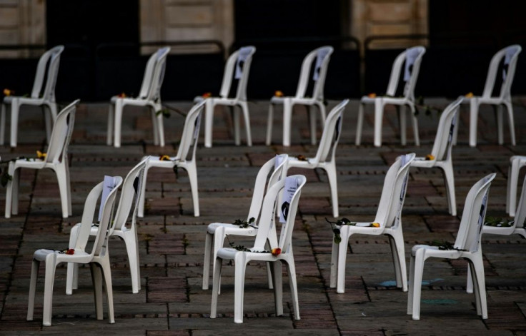 Chairs bearing the names of health workers who died from Covid-19 are set up during a protest against he Colombian health system
