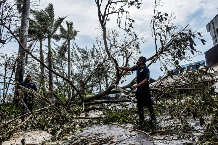 Municipal police remove fallen trees from the streets after the passage of Hurricane Zeta, in Puerto Morelos, Quintana Roo state, Mexico