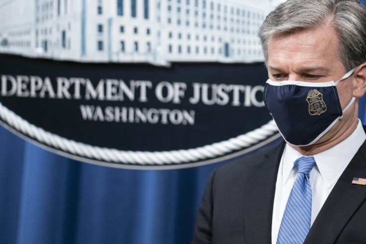 FBI Director Christopher Wray at a press conference announcing the arrst of five Chinese agents for their role in an operation targeting opponents of the Chinese government