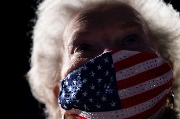 A mask wearing Trump supporter attends a rally Omaha