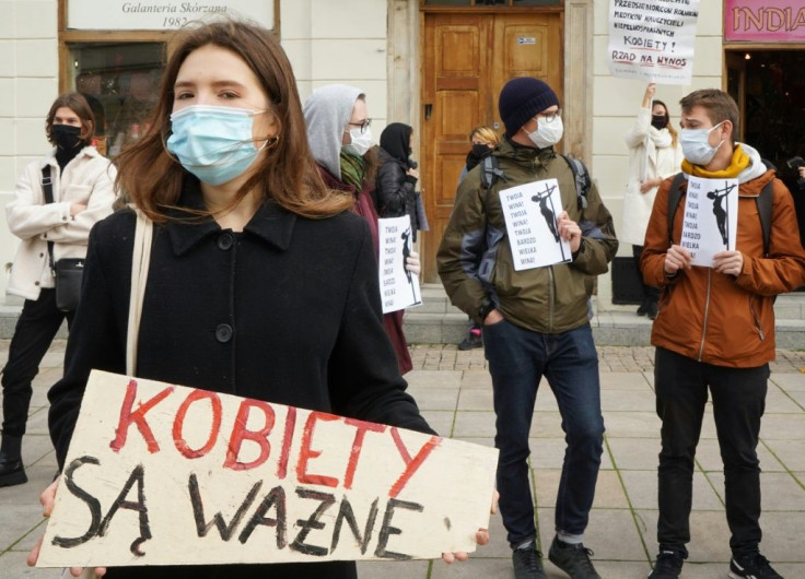 A woman holds a placard which reads 'Women are important' during protests in front of church. Anger has been mounting against the Catholic Church's support for legal case that brought about a further tightening of abortion restrictions