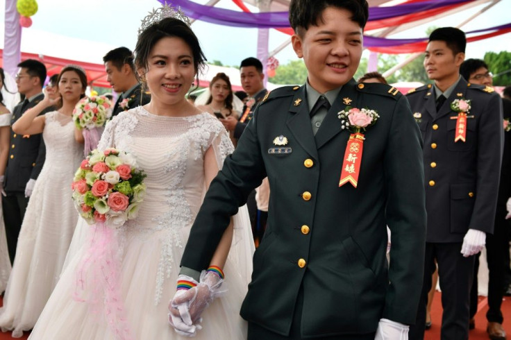 Same-sex couple Chen Ying-hsuan (R) and Li Li-chen take part in a mass wedding hosted by the Taiwanese military