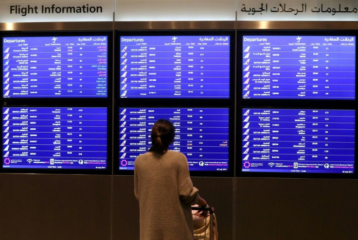 A passenger checks the departures board at the Hamad International Airport in Doha, Qatar in this file picture taken on March 7, 2017