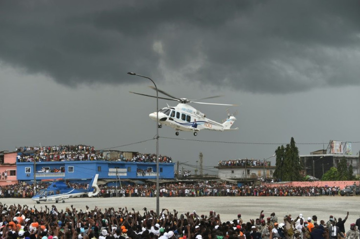 President Alassane Ouattara used a helicopter to make a dramatic appearance at his final rally on Thursday