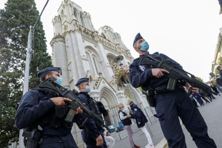 Armed police stand guard at the Notre-Dame de l'Assomption Basilica in Nice where the deadly attack took place