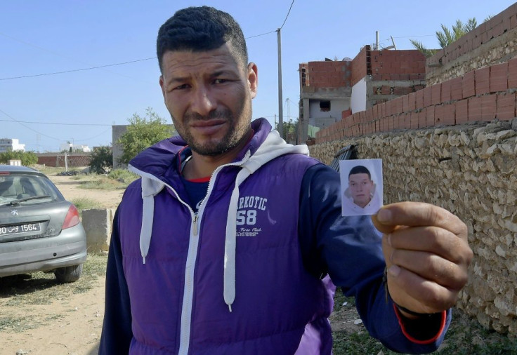 Yassin, the brother of the Nice assailant Brahim Issaoui, holds a passport picture of his sibling and says the family is struggling to believe he was responsible for the brutal killings