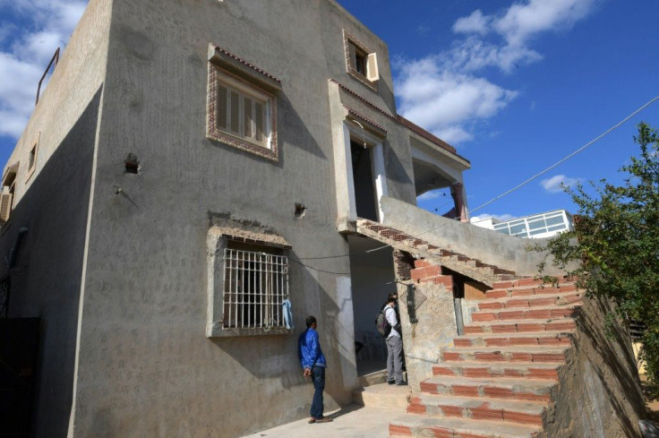 Neighbours stand by the family home of  Nice assailant Brahim Issaoui in a working class neighbourhood near an industrial zone on the outskirts of the Tunisian city of Sfax