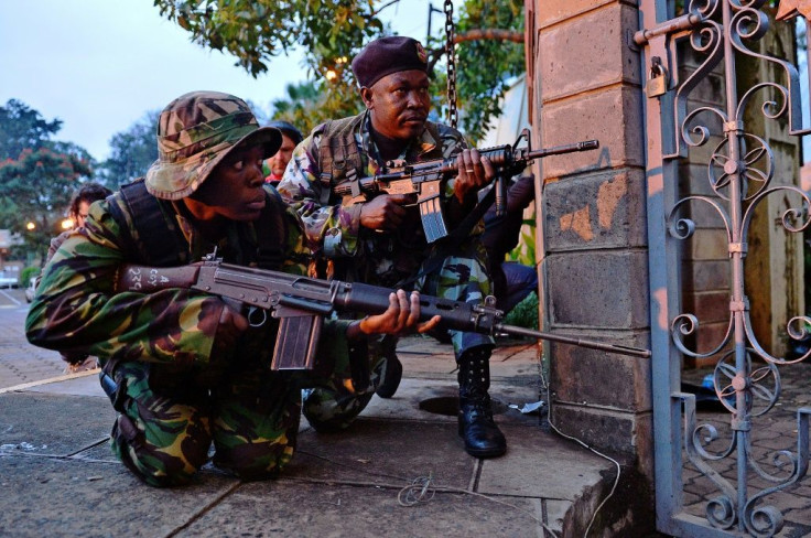 Kenyan soldiers take cover as heavy gunfire breaks out during the siege