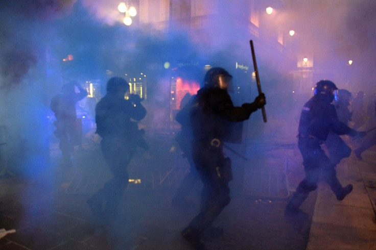 Members of the Catalan regional police force disperse a demonstration against new coronavirus restrictions in Barcelona.