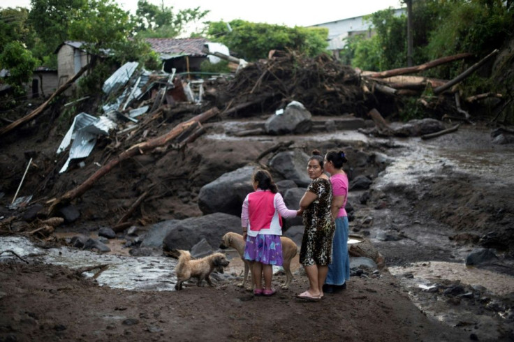 Survivors of the landslide that buried some 50 homes look at washed away buildings in Nejapa, just outside the city of San Salvador, on October 30, 2020