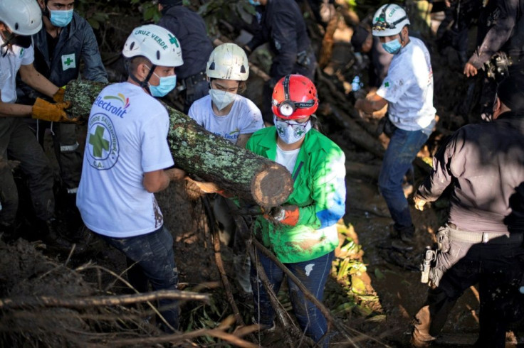 Rescuers work to remove rubble while searching for victims of a landslide in Nejapa, El Salvador on October 30, 2020