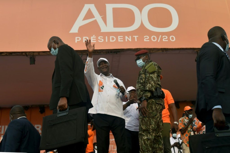 Opponents say Ivory Coast incumbent president Alassane Ouattara's (C) bid for a third term is illegal