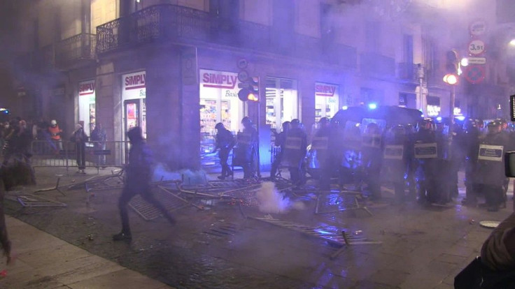 Police and demonstrators clash in Barcelona at a protest over virus restrictions