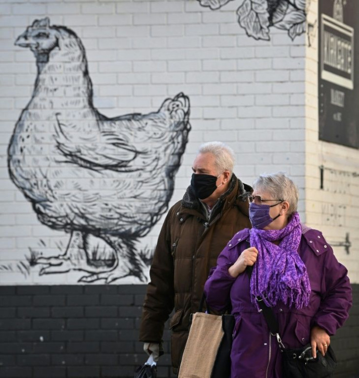 Shoppers walk past a mural at Kirkgate Market in Leeds on October 31, 2020, as the number of cases of the novel coronavirus COVID-19 rises.