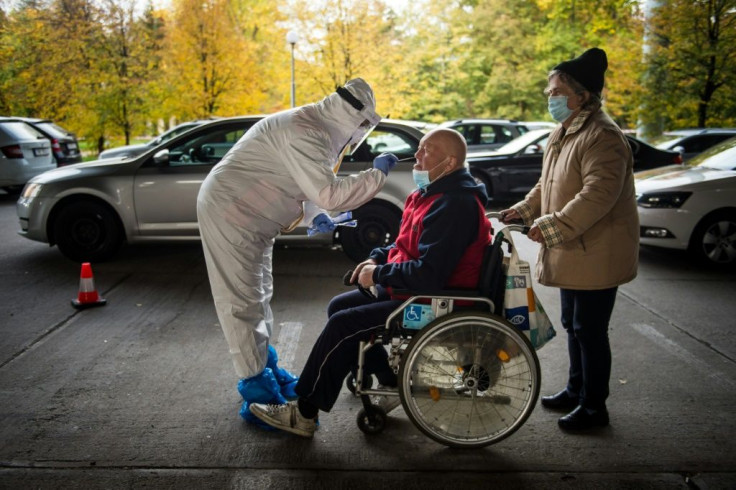 A medic tests a man for the novel coronavirus during nationwide testing in Bratislava, Slovakia on October 31, 2020.