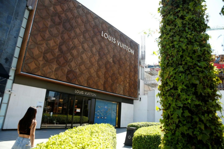 A woman walks past a luxury store at Las Condes commune in Santiago on October 31, 2020