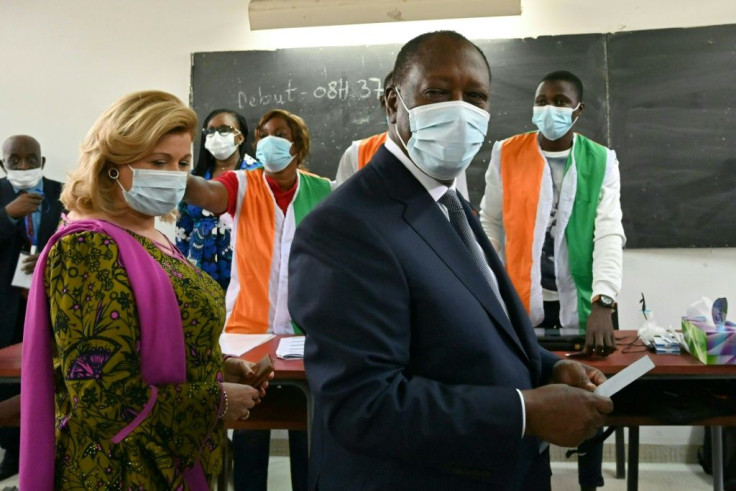 Ivorian President Alassane Ouattara (R) angered the opposition with his bid for a third term