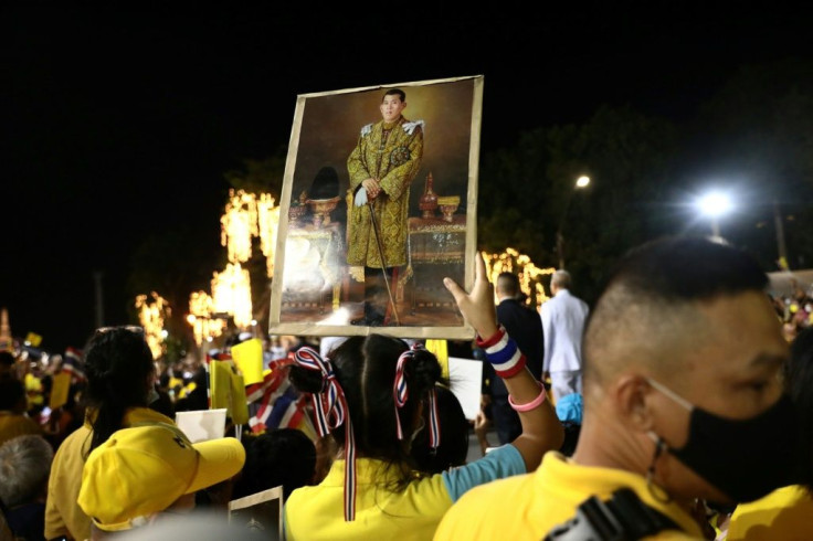 A royalist supporter holds a portrait of Thailand's King Maha Vajiralongkorn