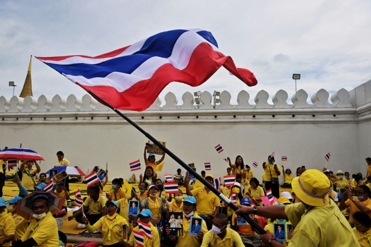 Royal devotion was on display as thousands of supporters, some waving flags, waited for the King and Queen near the Grand Palace