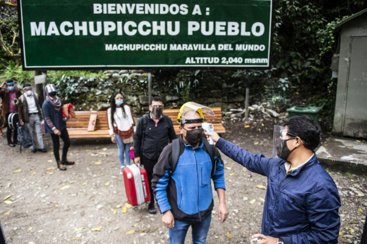 Visitors to the hamlet of Machu Picchu, also known as Aguas Calientes, get their temperature before they can visit the Inca ruins