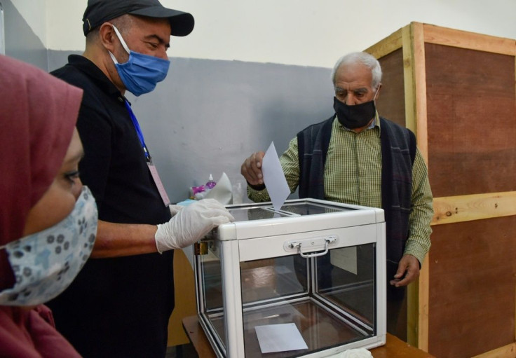 An Algerian man casts his ballot at a polling station in the capital Algiers during a referendum on a revised constitution