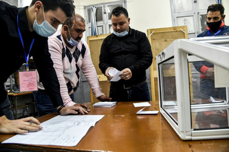 Poll station workers count the ballots of a vote on a revised constitution after voting ended at a station in Algeria's capital Algiers on November 1, 2020