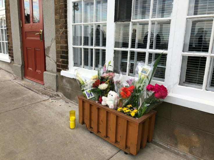 Flowers and a candle are placed in front of the house of a woman who died in a Halloween attack in Quebec City