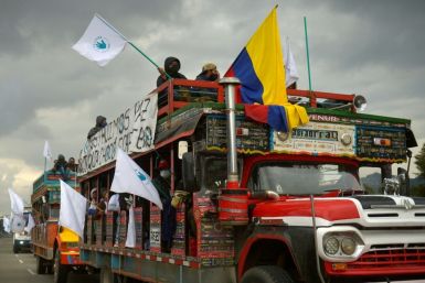 Former FARC guerrilla members riding in "chivas" (local transport vehicles) arrive in Bogota, Colombia to protest the murder of hundreds of ex-combatants