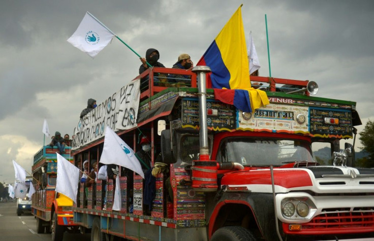 Former FARC guerrilla members riding in "chivas" (local transport vehicles) arrive in Bogota, Colombia to protest the murder of hundreds of ex-combatants