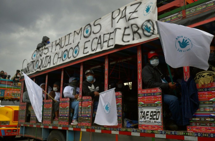 FARC demonstrators banged drums, blew trumpets and waved banners and flags in Bogota while protesting against violence towards former members