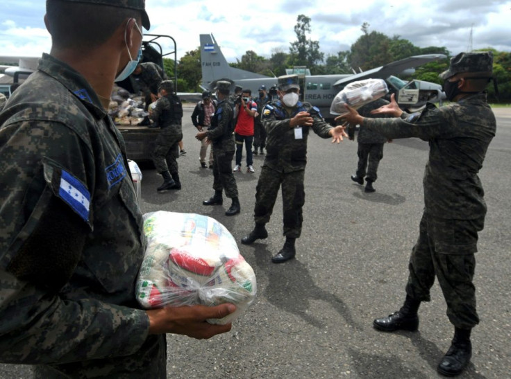 Honduran Air Force members load supplies on planes, to be taken to residents of Puerto Lempira municipality, department of Gracias a Dios, in preparation for the arrival of the upcoming Hurricane Eta, in Tegucigalpa, on November 2, 2020