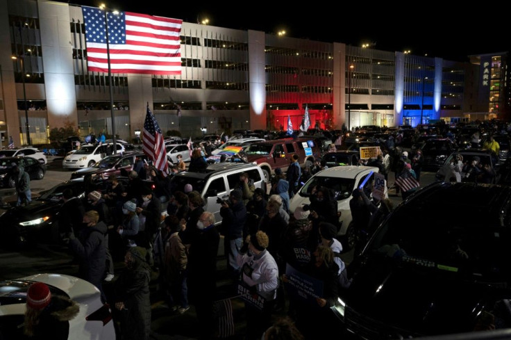 Supporters listen -- and honk -- as Democratic presidential candidate and former US vice president Joe Biden speaks during a drive-in rally in Pittsburgh, Pennsylvania in the closing hours of the 2020 campaign