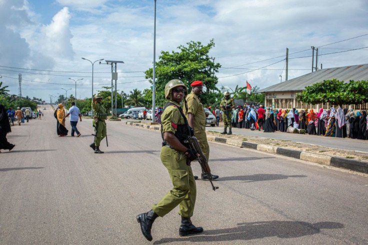 Tanzanian police officers last week patrol outside Garagara Playground polling station in Mtoni, Zanzibar.