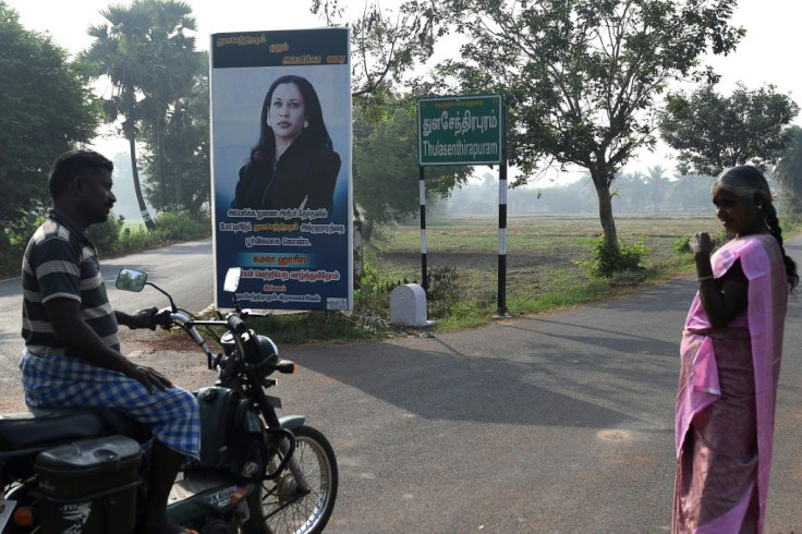 A motorcyclist rides past a poster of US Democratic vice-presidential candidate Kamala Harris at her ancestral village of Thulasendrapuram in the southern Indian state of Tamil Nadu