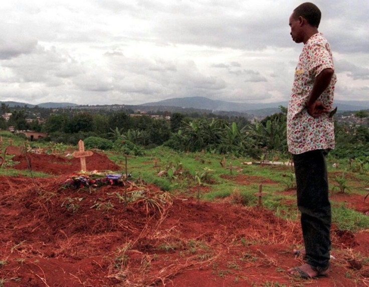 A man stands in front of the grave of a victim of the 1994 massacre in the "genocide cemetery" of Kigali
