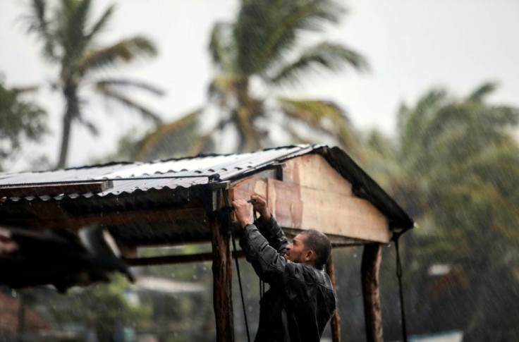 A man struggles to protect his house as Hurricane Eta bore down on Nicaragua's northern Caribbean coast