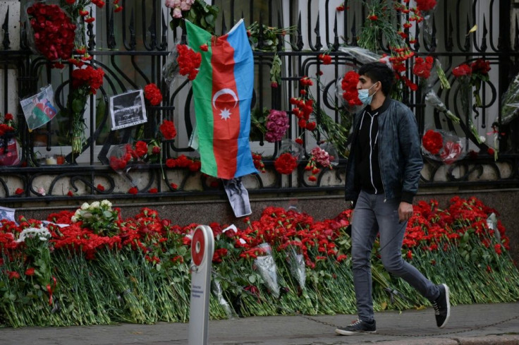 A man walks past a makeshift memorial outside the Azerbaijani embassy in Moscow for Azerbaijanis killed in the conflict over Nagorno-Karabakh