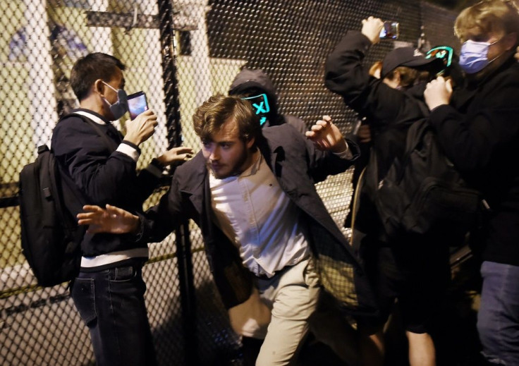 A Trump supporter tries to run from demonstrators at Black Lives Matter plaza across from the White House on Election Day