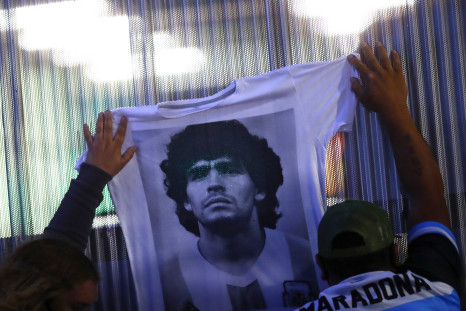  Fans hold a jersey with the face of Diego Maradona at Clínica Olivos on November 03, 2020 in Olivos, Argentina.