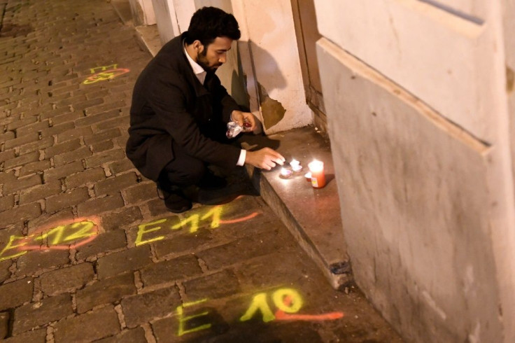A man lights candles near the scene of the deadly shooting in Vienna