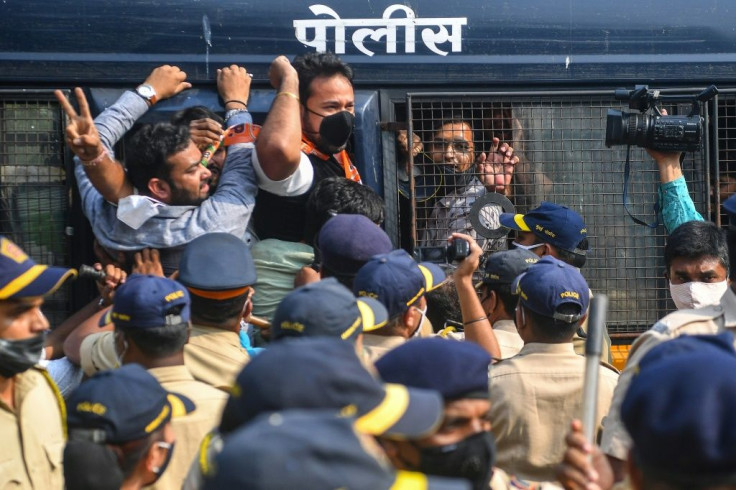 Activists and supporters of the Bharatiya Janata Party shout slogans as they are detained by the police while protesting against the arrest of Goswami