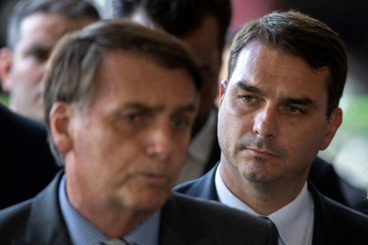 President Jair Bolsonaro's son Flavio (R, with his father, L) has been charged with corruption