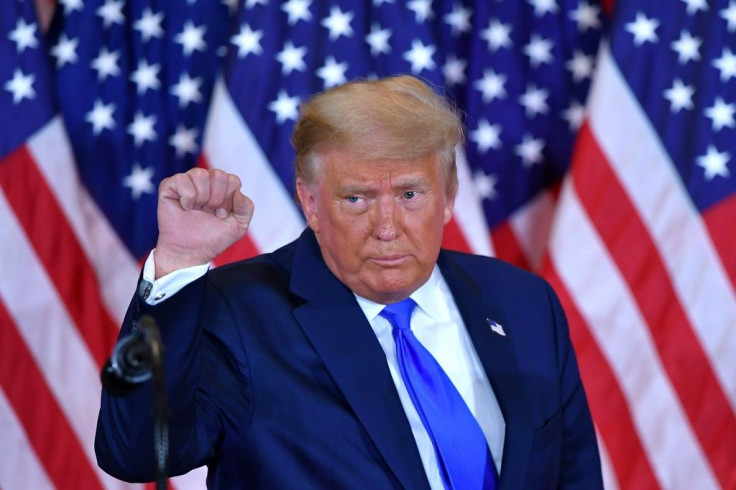US President Donald Trump pumps his fist after speaking in the East Room of the White House in Washington, DC early on November 4, 2020
